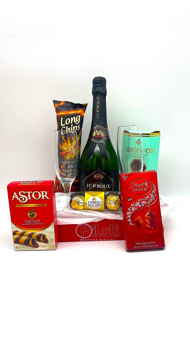 A gift basket arrangement featuring a bottle of J.C.